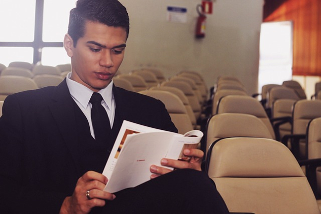 10 Leadership Myths That Could Hold You Back from Success a young man sitting reading in an empty lecture hall